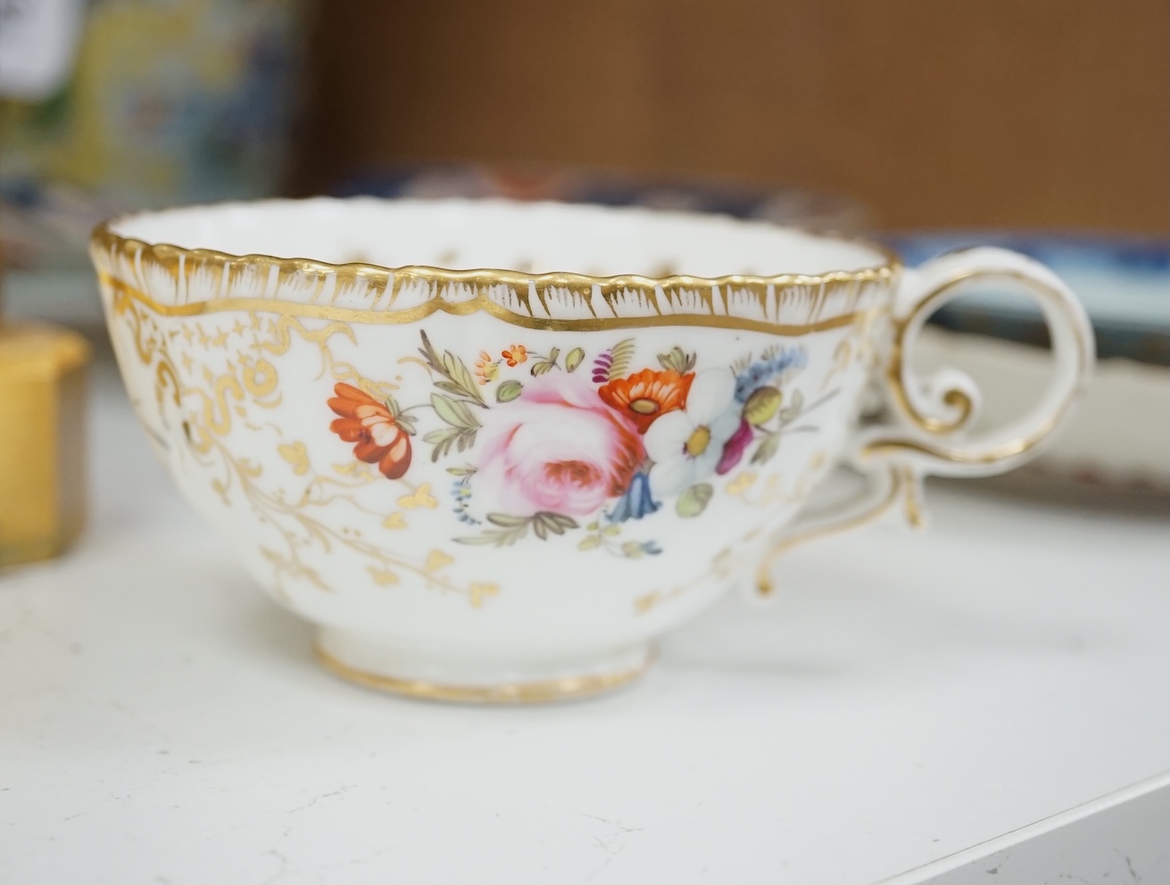 A Coalport floral part teaset, c.1825, to include teapot, sandwich plates and cups & saucers. Condition - poor to fair